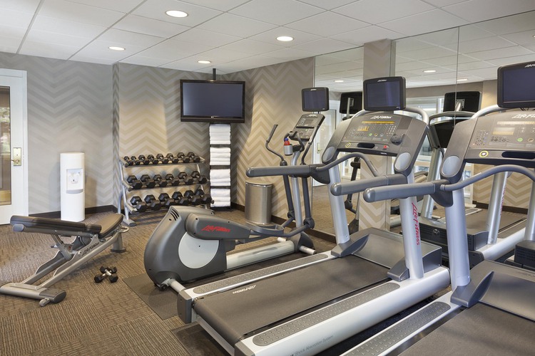 Treadmill, free weights, elliptical, and TV in fitness centre